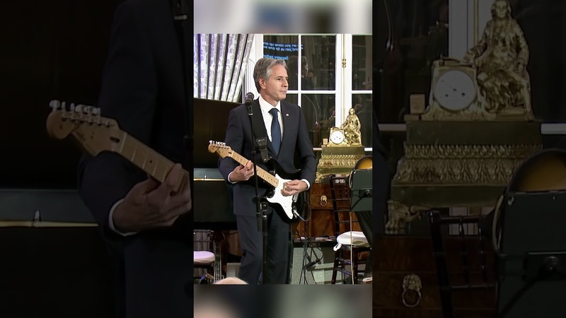 Secretary of State Blinken plays guitar at the launch of the Global Music Diplomacy
