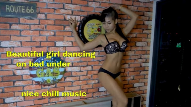 Beautiful girl dancing on bed under nice chill
