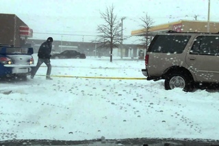 STI helping a suv stuck in the snow