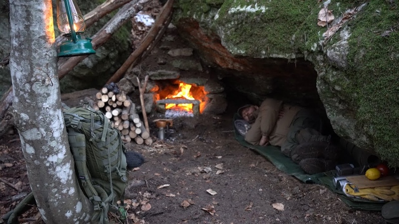 Excavate a natural shelter. Stone fireplace with chimney. Sleeping in the wild. Survival